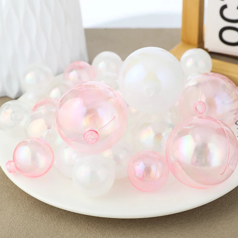 A cluster of clear and pink iridescent balloons used as cake toppers for party desserts.