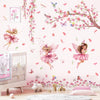 Pink butterfly tree fairy wall decals featuring pink and purple floral elements on a white wall.