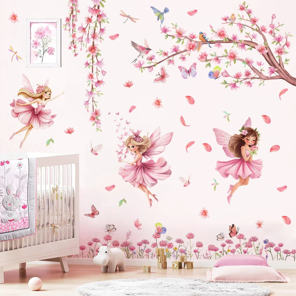 Pink butterfly tree fairy wall decals featuring pink and purple floral elements on a white wall.