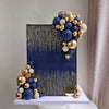 A set of blue, white, and gold ball cake toppers arranged in a vertical display.