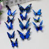 A collection of twelve colorful 3D butterfly wall decor stickers in various shades of blue and purple.