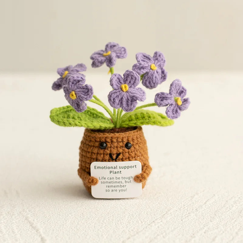 Handmade crochet sunflower desk companion with a smiling face made of brown yarn and purple flowers