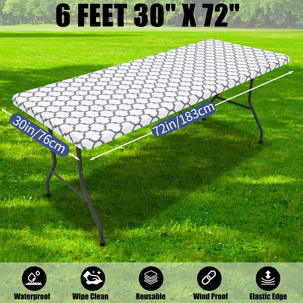 A waterproof elastic fitted tablecloth for a 6-foot folding table, shown spread out on green grass.