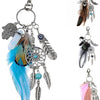 Bohemian dream catcher keychain featuring a blue feather, silver beads, and a dark brown feather tassel.