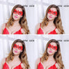 A woman models a red lace masquerade mask for Halloween and costume parties.
