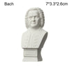 A white plaster bust miniature of Bach, featuring his head and shoulders.