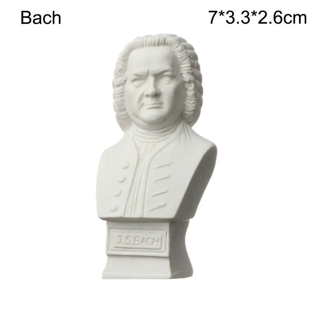 A white plaster bust miniature of Bach, featuring his head and shoulders.