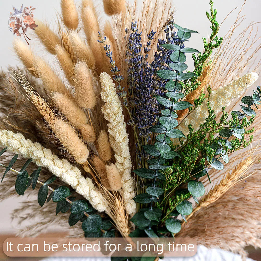 A dried flower bouquet featuring various grasses, lavender, and eucalyptus greenery.