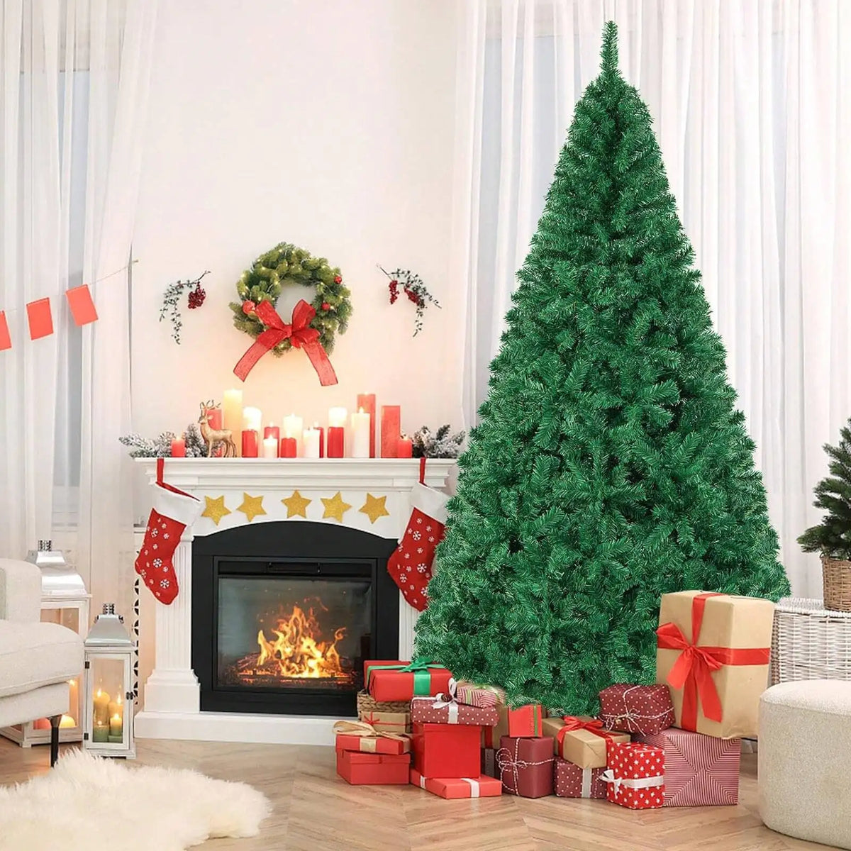 A tall green artificial Christmas tree decorated with red ornaments and gifts in a bright living room setting.