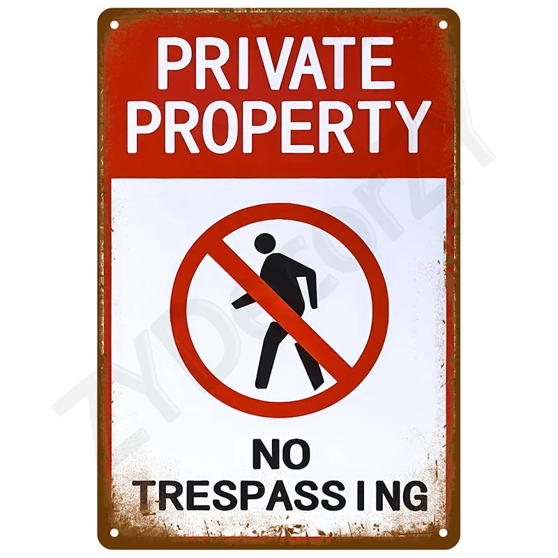 A vintage rusted metal sign with white text reading PRIVATE PROPERTY and NO TRESPASSING.
