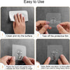 Demonstration of how to use heavy duty self-adhesive wall hooks, showing cleaning, removing the film, and pasting the hook.