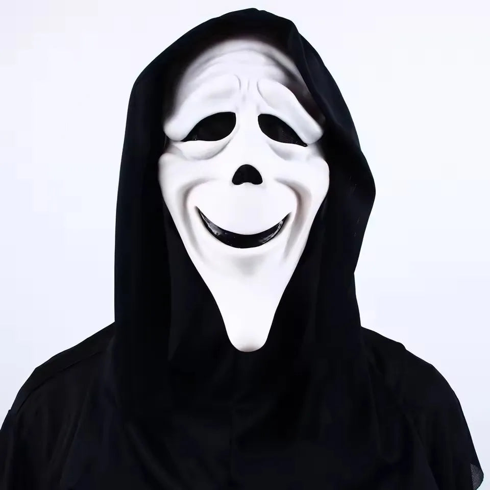 A white screaming skeleton horror mask with a black hood and smiling facial expression.