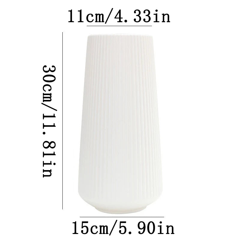 White ceramic vase with vertical ribbed texture, measuring 11cm high.