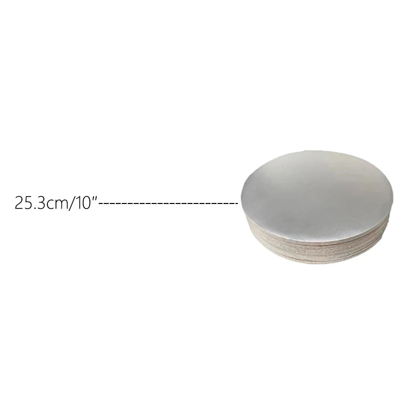 A stack of round, light gray cardboard cake boards with a dimension marker showing 25.3cm or 10 inches.