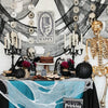A spooky Halloween decoration display featuring a table covered with blue fabric and black gauze fabric decorations.