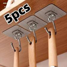 Five stainless steel adhesive wall hooks are displayed hanging from wooden rods for home organization.