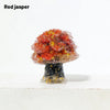A natural crystal mushroom tree sculpture with a reddish-orange top and a dark base.