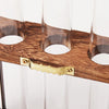 A wooden planter rack holds several glass test tube-shaped vases for hydroponic growing.