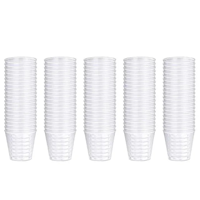 A set of 100 clear reusable plastic shot glasses arranged in a row.