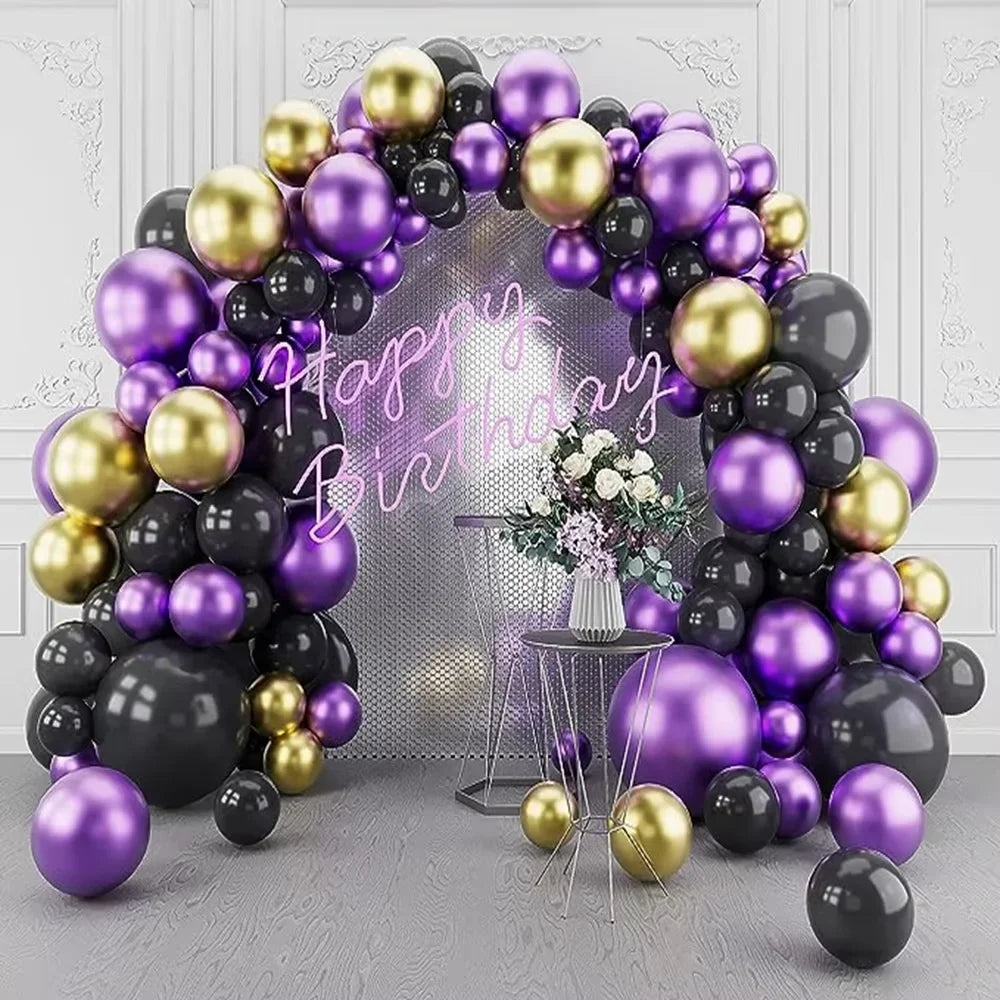 A dense archway of purple and gold latex balloons decorated for a birthday celebration.