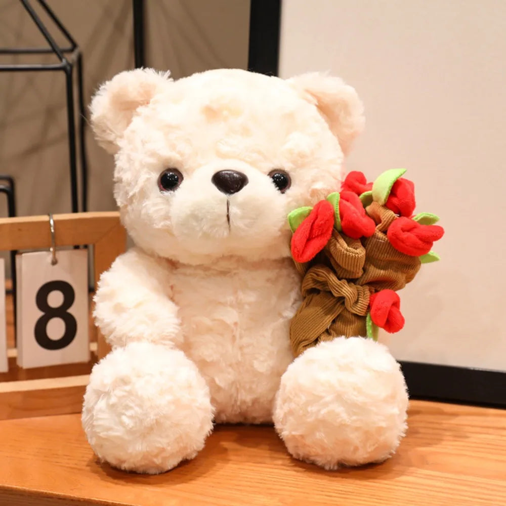 A fluffy white bear plush toy with dark eyes and a bouquet of red roses.