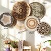A collection of round boho straw wall hangings with varying sizes and textures displayed against a light background.