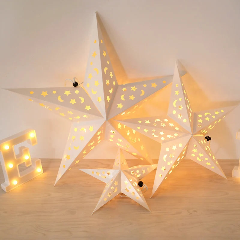A decorative light fixture shaped like a large star and the letter E, illuminating a room.