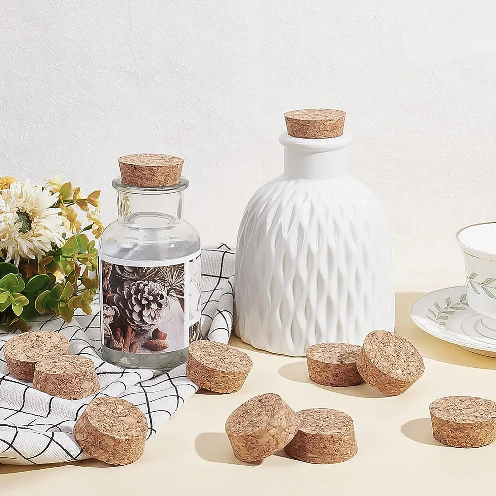 White ceramic bottle and several cork circles displayed on a light surface.