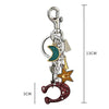 Silver zinc alloy keychain featuring a crescent moon charm, a star charm, and a ring charm.