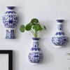 A collection of antique blue and white ceramic wall vases displayed against a white background.