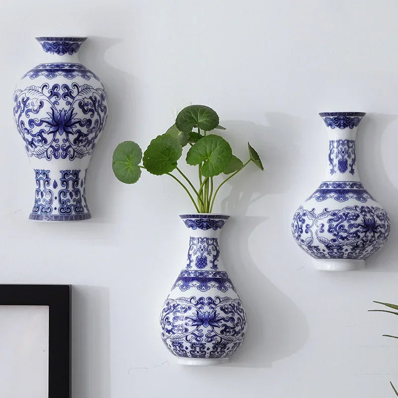 A collection of antique blue and white ceramic wall vases displayed against a white background.