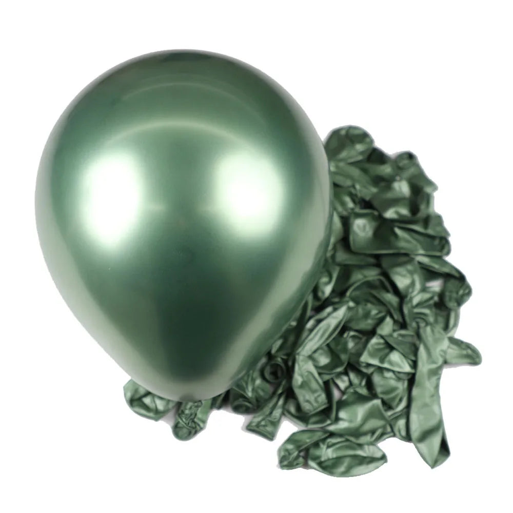 A single shiny metallic green latex balloon resting on a pile of crumpled green foil balloons.