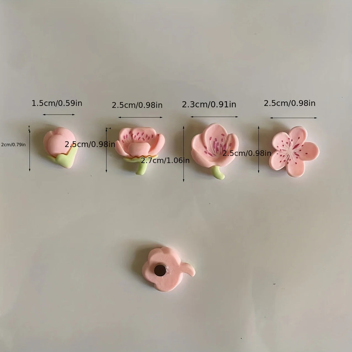 A set of twelve pink and purple flower decorative fridge magnets displayed with various sizes.