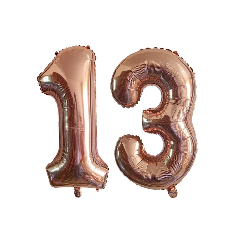 Two foil number balloons shaped like 1 and 3 in rose gold color
