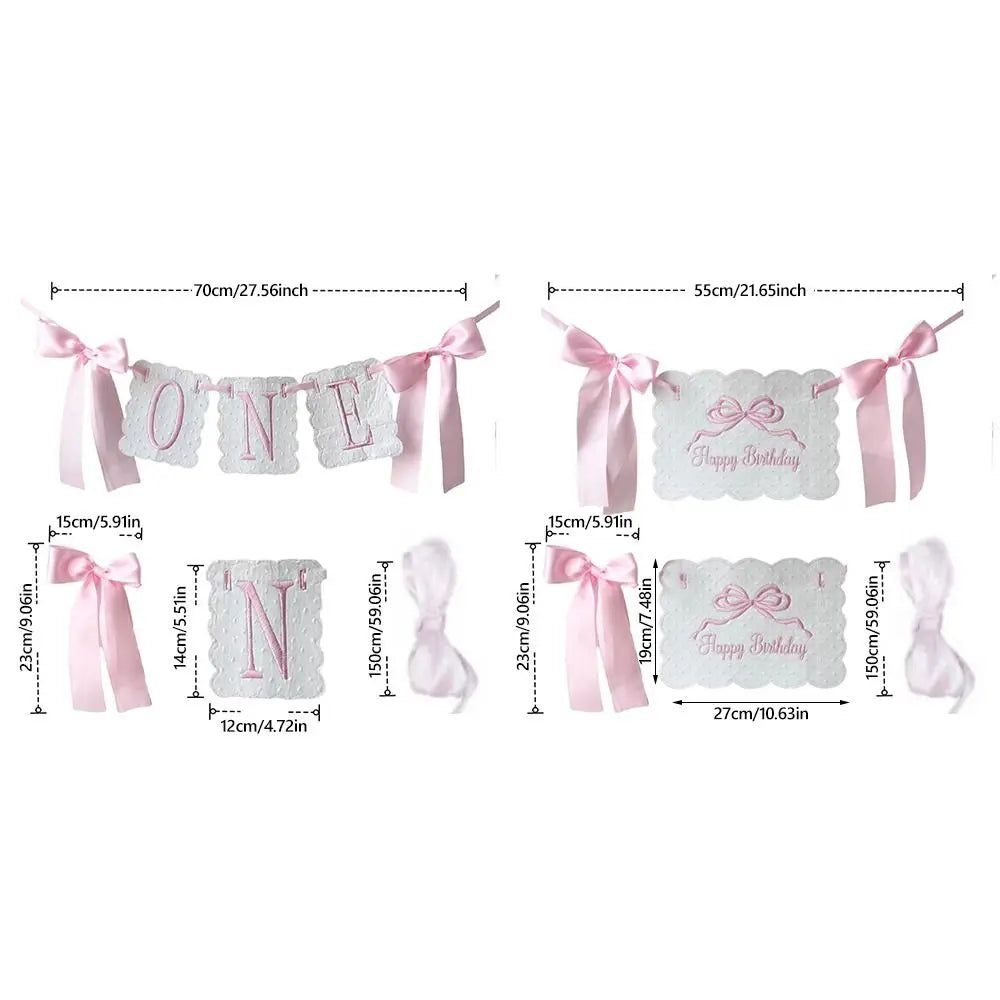 A decorative birthday garland featuring the number one in pink and white fabric for a first birthday celebration