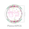 A plate decorated with pink roses, greenery, and a baby girl theme featuring a pink baby outfit and a light bulb.