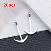 20 pieces of silver-colored vintage ship anchor charms for jewelry making displayed on a dark surface.