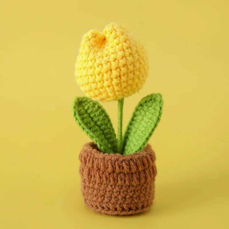 Handcrafted crochet yellow tulip growing in a brown pot