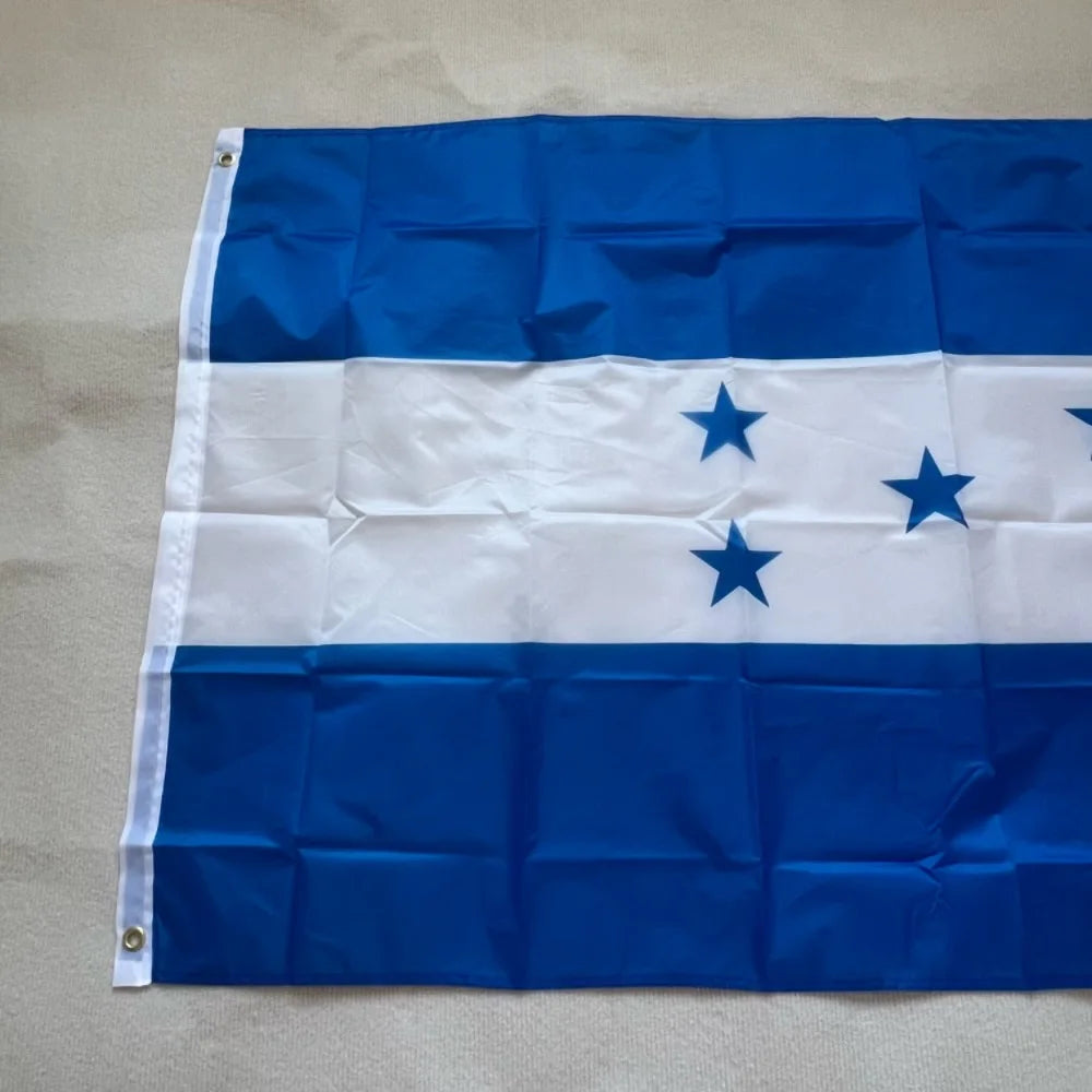 A blue and white flag of Honduras with blue stars on a white stripe, made of durable polyester fabric.