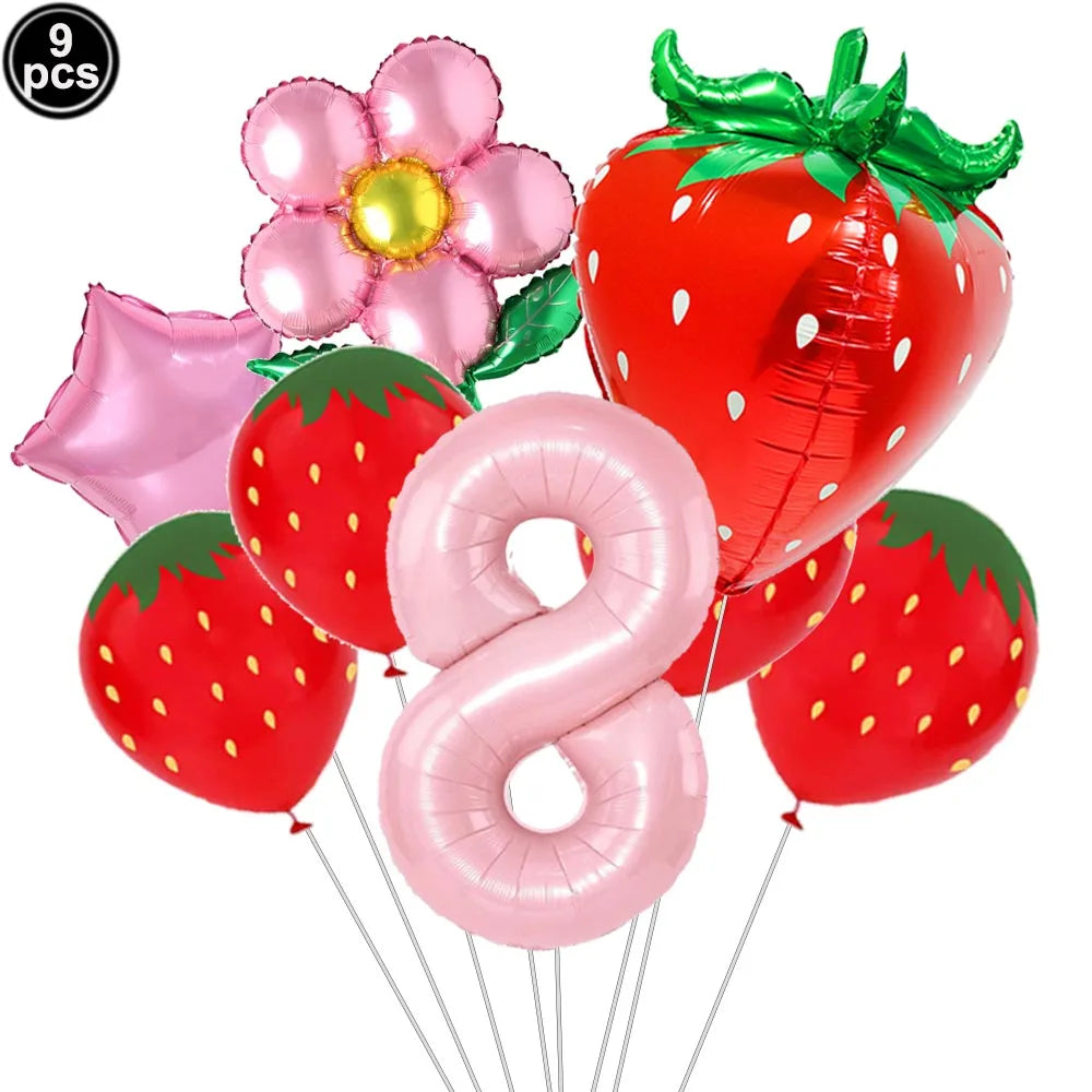 A set of nine pink and red balloons, including a strawberry shape and the number eight, for a party kit.