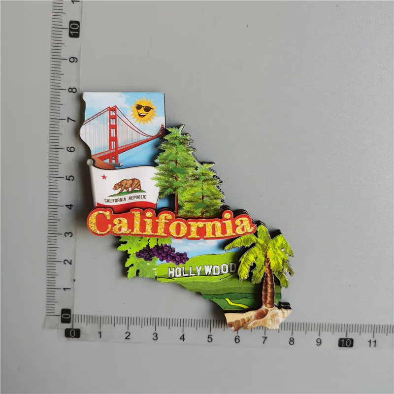 A set of iconic U.S. city fridge magnets featuring the Golden Gate Bridge, California state seal, and a California map outlin