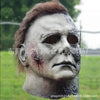 A weathered, gray horror mask resembling Michael Myers, used for cosplay or display.