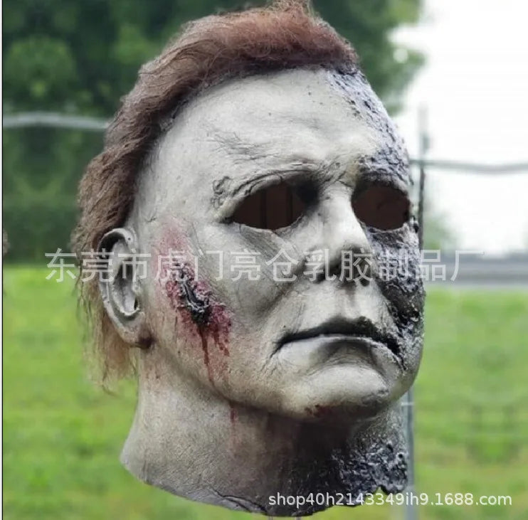 A weathered, gray horror mask resembling Michael Myers, used for cosplay or display.
