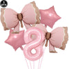 A set of pink bow shaped balloons for a disposable party tableware set