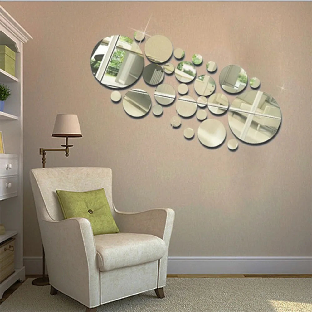 A beige armchair sits in a room with a wall decorated by a cluster of round mirrors.