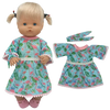 A doll outfit set featuring a light blue floral dress and matching pink trim, displayed next to the doll.