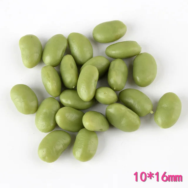 A pile of light green, oval resin fake corn miniatures for crafting and décor.