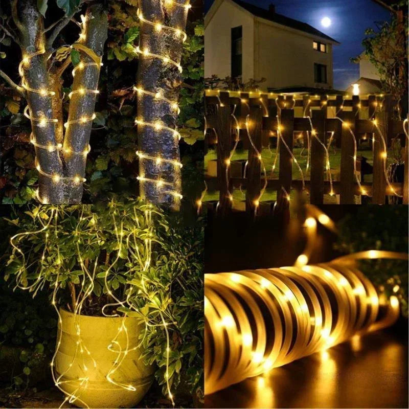 Outdoor decor featuring glowing LED rope lights wrapped around tree trunks and a wooden fence.