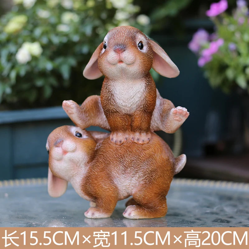 A hand-painted resin rabbit garden statue with brown fur standing on a gray surface.