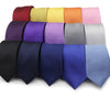 A row of solid color silk-feel neckties for men in various shades including red, yellow, orange, pink, purple, and blue.